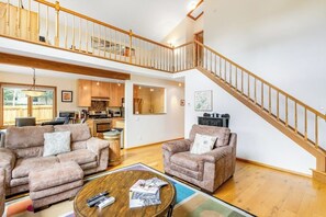 A spacious living area with two sofas, a coffee table, and a staircase leading to an upper level. - Mountain House + Loft w/Free WiFi, Enclosed Patio, Gas Grill, Cable (Silverthorne)