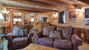 A rustic wooden interior with leather sofas and a dining area. - Remodeled Cabin In South Fork w/Free WiFi/Furnished Patio/Private Washer/Dryer (South Fork)