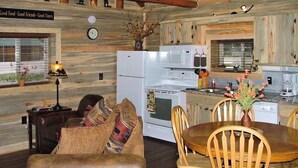 A log cabin interior with a dining area, kitchen, and a cozy living space. - Remodeled, Mountain View Cabin w/ Fireplace, Firepit & WiFi - Dogs Welcome (South Fork)