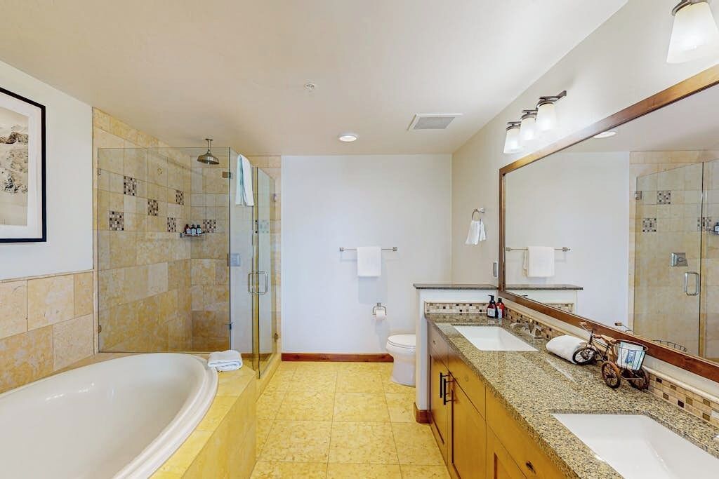 A bathroom with a bathtub, a shower, a toilet, and a sink.