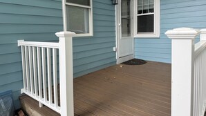 A porch with a white railing, a door, and a window. - Private Suite with Full Bath & Separate Entrance –  close to Tufts University (Winchester)