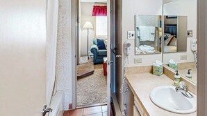Een badkamer met een wastafel, spiegel en toiletartikelen.