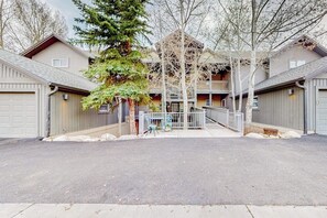 A multi-story building with a central courtyard, a covered outdoor seating area, and a garage on the ground floor. - Riverside condo with central A/C and walk-out patio at the foot of Beaver Creek (Avon)