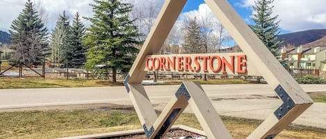 A sign with the word 'CORNERSTONE' in a diamond-shaped structure.