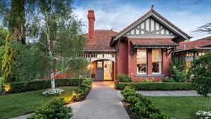 A brick house with a herringbone driveway, a chimney, and a well-maintained garden. - Luxury Seaside Estate with Pool & Garden Oasis (Brighton)