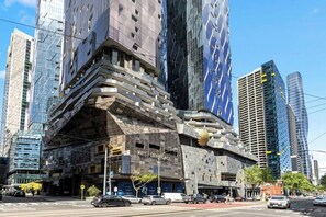 A modern building with a unique architectural design, featuring a prominent entrance labeled 'WEST SIDEPLACE.' - Executive stunner in West Side Place with Parking (Melbourne)