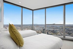A high-rise hotel room with a large window offering a city view. - Xia -Jaw-dropping 3BD2BTH Executive City Residence (Melbourne)