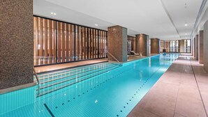 A long indoor swimming pool with clear water, tiled walls, and a modern design. - Luxe Docklands Townhouse with 2 Carspaces +Views! (Docklands)