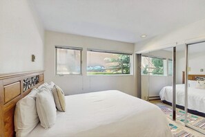 A bedroom with a bed, a window, and a sliding glass door leading to another room. - Steps to Ski Shuttle Condo w/ Fireplace, WiFi & Shared Hot Tub/Seasonal Pool (Vail)