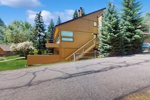 A modern two-story building with a wooden exterior, a staircase, and a balcony. - Steps to Ski Shuttle Condo w/ Fireplace, WiFi & Shared Hot Tub/Seasonal Pool (Vail)