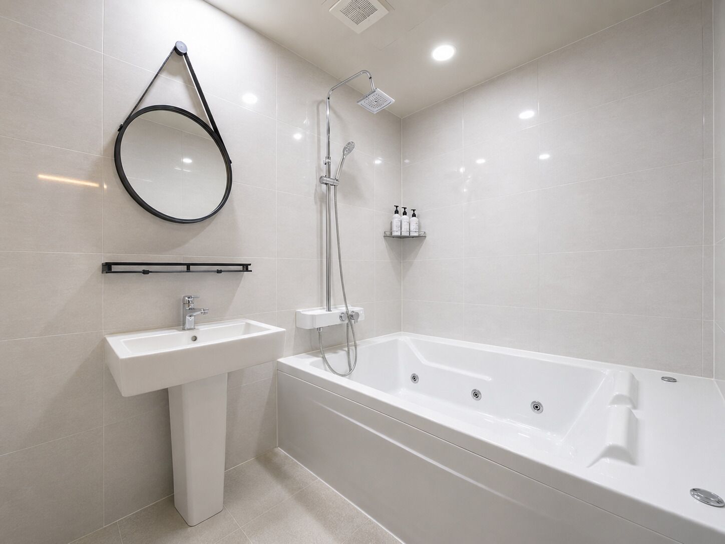 A modern bathroom with a white sink, a bathtub, a shower, and a round mirror.