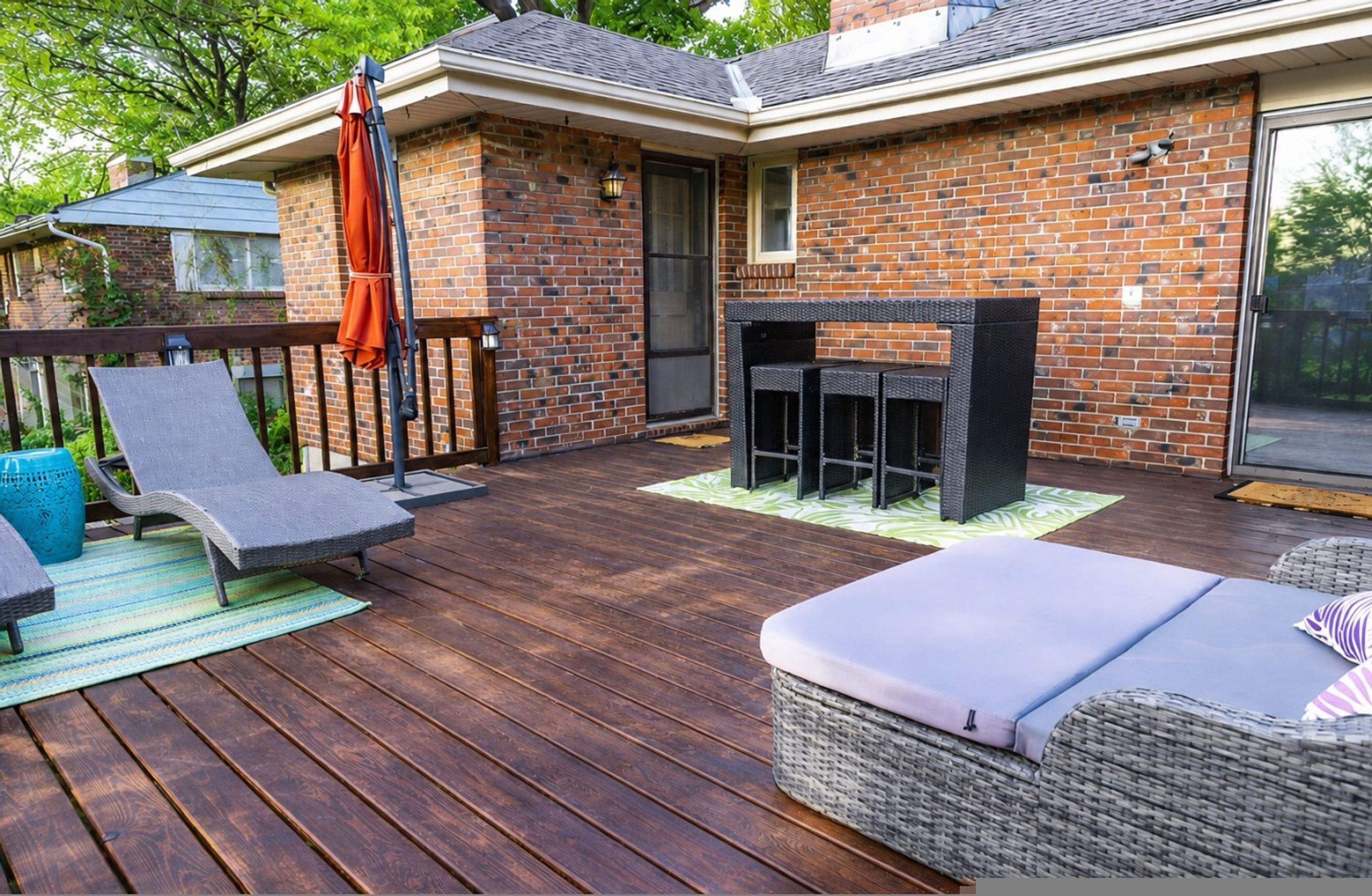 A patio with outdoor furniture, a fire pit, and a brick wall.