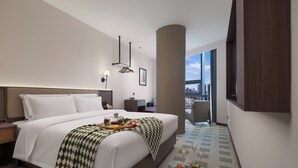 A modern hotel room with a large bed, a city view, a dining area, and a balcony. - K.K Fashion Hotel (Chongqing)