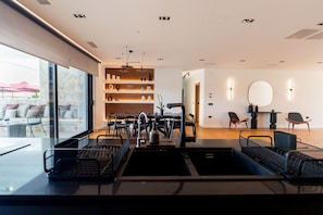 A modern interior with a dining area, kitchenettes, and a seating area with a view. - Villa in Corfu with 7 bedrooms sleeps 14 (Corfu)