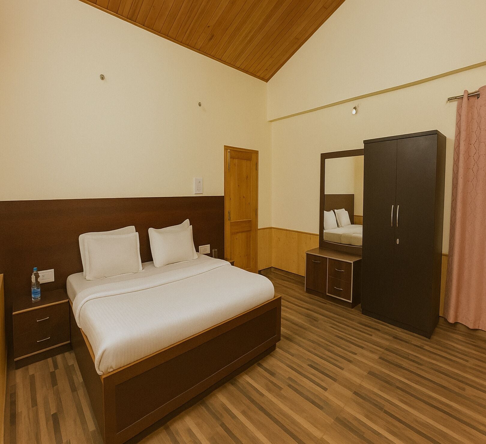A bedroom with a wooden bed, a wardrobe, a mirror, and a nightstand.
