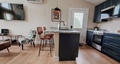 Peaceful one-bedroom mountain retreat in Floyd, Virginia featuring a full kitchen, cozy living space, private outdoor seating, and shared fire pit access just minutes from downtown Floyd.