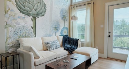 Peaceful one-bedroom mountain retreat in Floyd, Virginia featuring a full kitchen, cozy living space, private outdoor seating, and shared fire pit access just minutes from downtown Floyd.