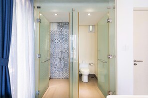A modern bathroom with a glass shower enclosure, a toilet, and a sink. - Oceanami Long Hai Managed by Villa Owner (HO CHI MINH CITY)