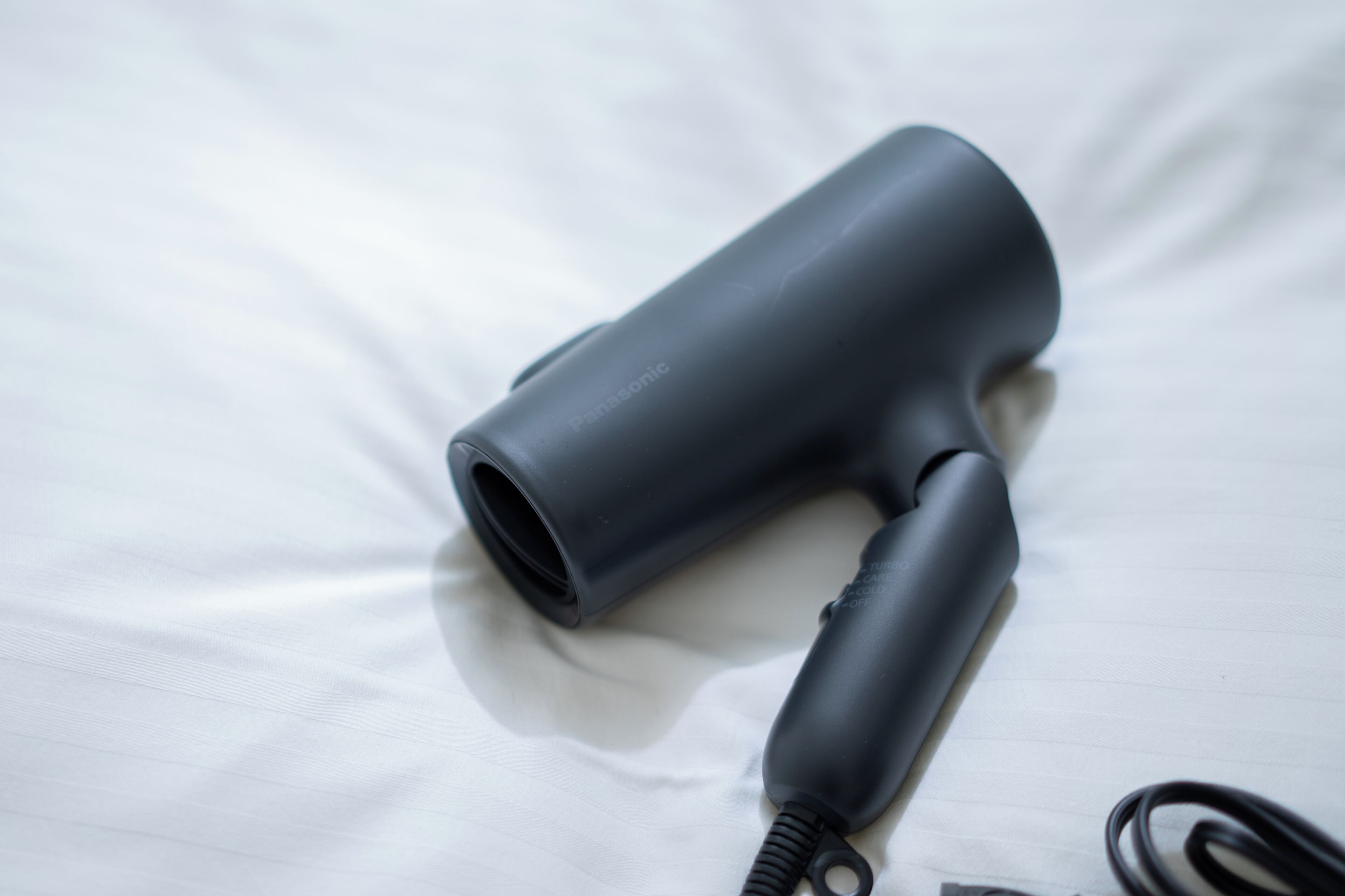 A hair dryer on a white surface.