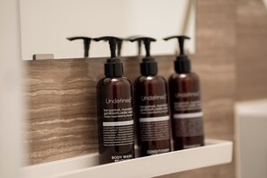 Three body wash bottles on a shelf. - stella stay (Imari City)