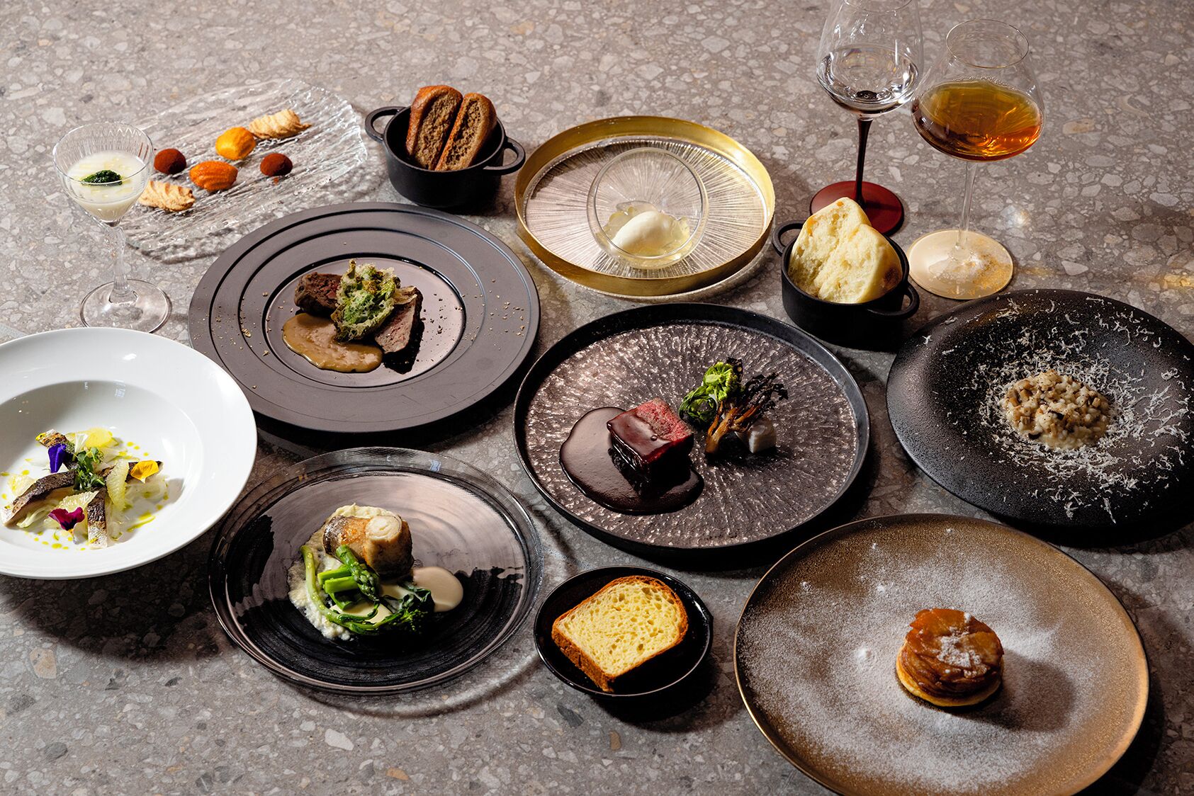 A variety of dishes and glasses on a table.