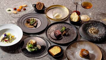 A variety of dishes and glasses on a table.