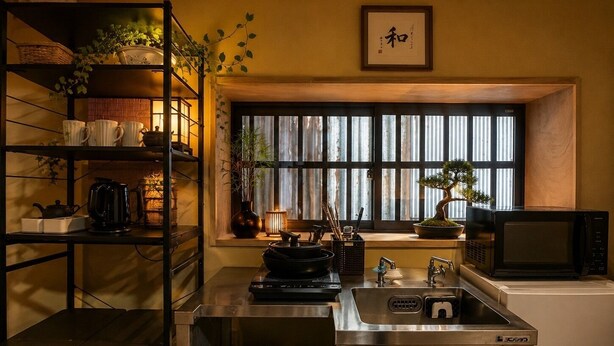A kitchen with a sink, stove, microwave, and shelves with kitchenware. - Quiet inn in Takatsuki/6 min. from station/13 min. from Kyoto, 15 min. from Osaka/ 1 hr. from Kansai Airport by direct train/ Japanese-style old private house/ Max. 10 people (including children)/ Projector (Takatsuki City)