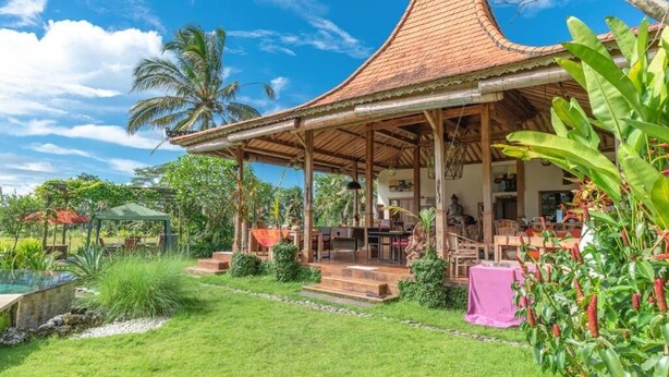 A traditional house with a tiled roof, a covered patio, and a pool. - Bali Sawah Indah  (Tampaksiring)