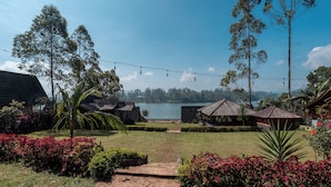 A view of a lake with a pathway leading to a wooden structure, surrounded by greenery and a clear sky. - TB Villa Resort By ARBA (Pangalengan)