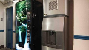 A vending machine with a waterfall display and a water dispenser.