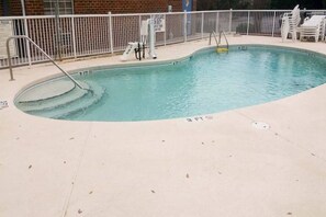 A swimming pool with a 3 FT depth marking, a lifeguard stand, and a fenced area with lounge chairs. - 1 Queen Bed|Non-Smoking, Kitchen (Myrtle Beach SC)