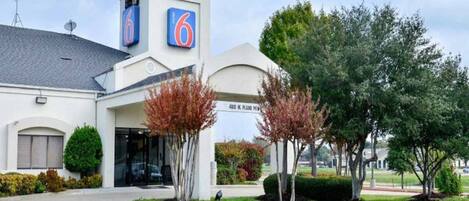 A 6 hotel with a modern design, a prominent entrance, and a fire lane.