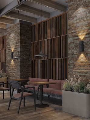 A modern interior with a wooden wall, a seating area, and pendant lighting. - Lake Charvak Resort (Burchmulla)