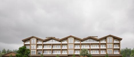A multi-story hotel with a symmetrical facade, large windows, and a flat roof.