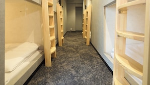 A hotel corridor with bunk beds and wooden shelves along the walls. - Guesthouse Akasaka2 (Tokyo)