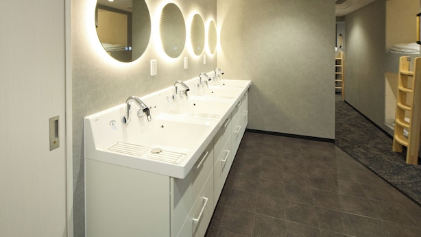A modern bathroom with three sinks, a mirror, and a wooden ladder. - Guesthouse Akasaka2 (Tokyo)