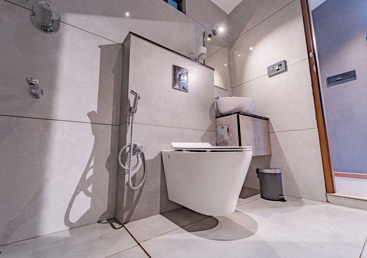 A modern bathroom with a freestanding bathtub, a shower, and a toilet.
