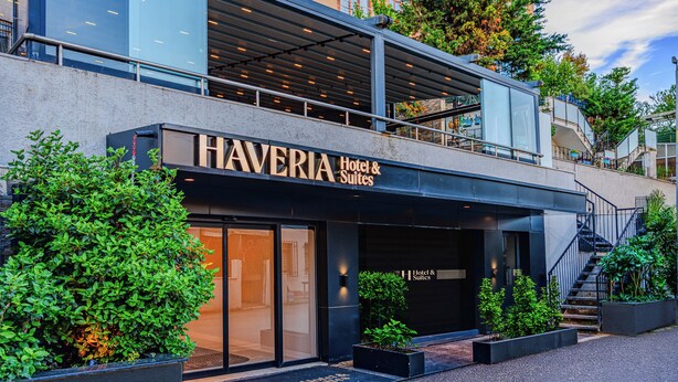 A modern hotel with a prominent entrance, outdoor seating, and a staircase leading to an upper level. - Haveria Suite Hotel (Istanbul)