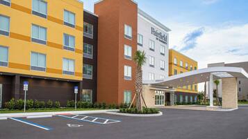 A hotel with multiple buildings, a parking lot with handicapped accessible spaces, and a covered entrance.