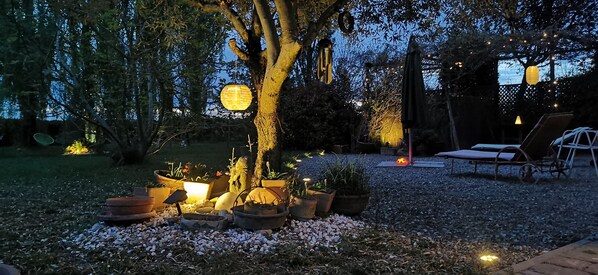 A garden area with potted plants, a tree, and outdoor furniture. - Farmhouse with garden, parking and fitness area near Bologna center (Bologna, Emilia-Romagna)