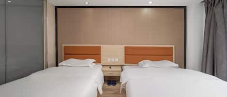 A hotel room with two beds, a wooden headboard, a nightstand, and a window with curtains.