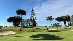 A golf course with trees, a sand bunker, and a clear sky. - Casa Mar-Luxury Apartments Islantilla-RuitenAppartementen (Lepe)