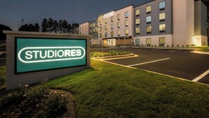 A hotel named 'STUDIORES' with a modern building, a parking lot, and a well-maintained lawn. - StudioRes by Marriott Wilmington (Wilmington)