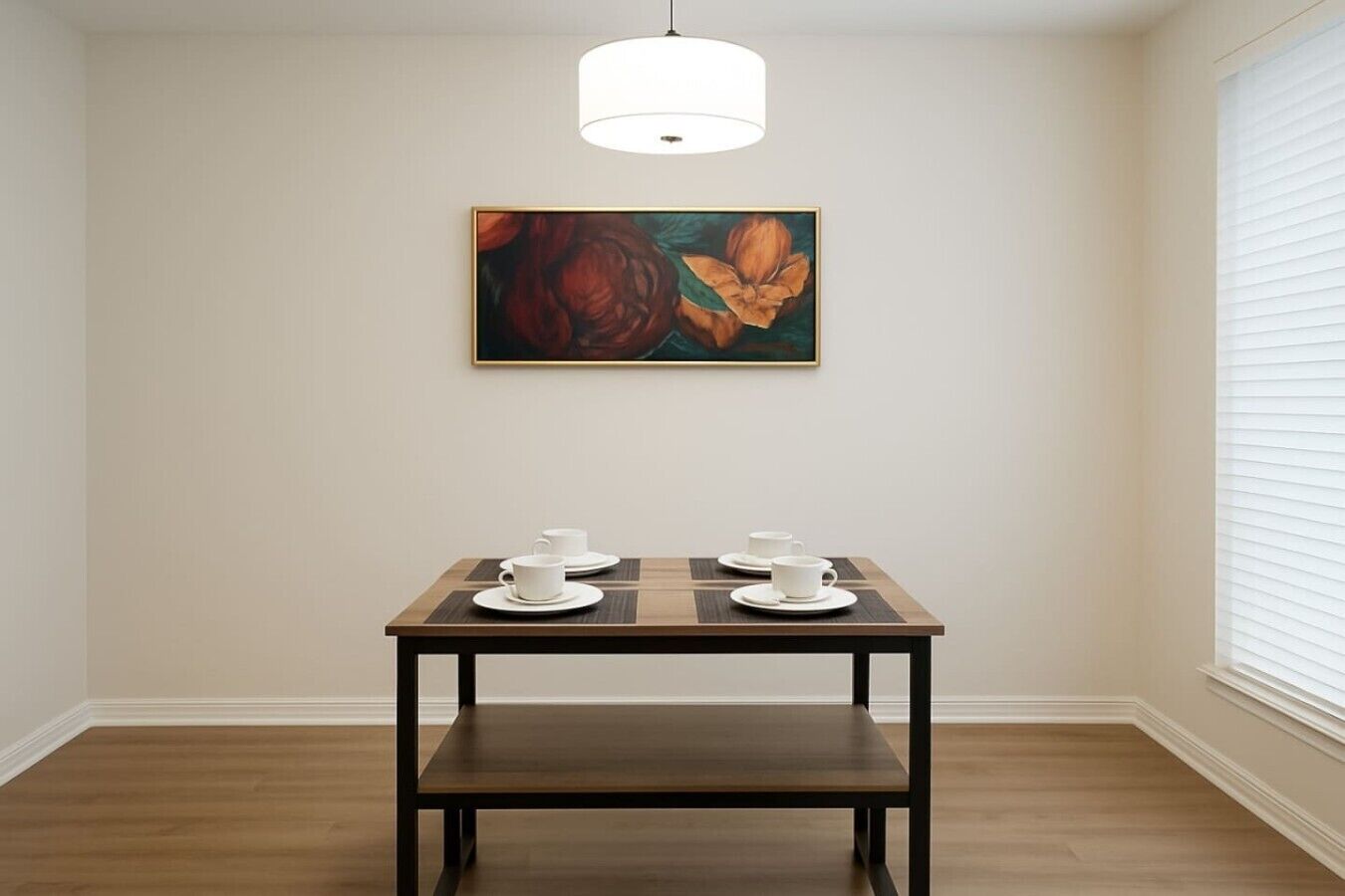 A dining area with a table, chairs, and a painting on the wall.