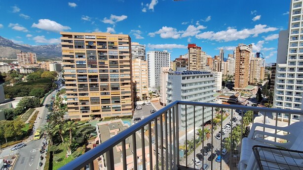 A cityscape with high-rise buildings, a clear sky, and a balcony with a white toilet. - FLECHA (3 BEDROOMS) (Benidorm)