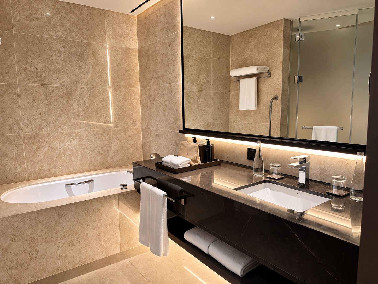 A modern bathroom with a bathtub, two sinks, a large mirror, and a glass shower enclosure.