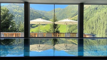 Indoor pool, open 11:00 AM to 7:00 PM, pool umbrellas, pool loungers