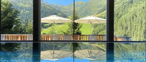 Indoor pool, open 11:00 AM to 7:00 PM, pool umbrellas, pool loungers