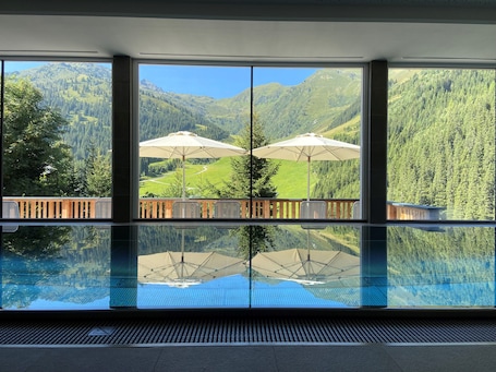 Indoor pool, open 11:00 AM to 7:00 PM, pool umbrellas, pool loungers. Hotel Zirbenhof