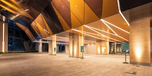 A spacious lobby with a modern architectural design, featuring a geometric ceiling and illuminated lines. - Jewel Oxley by KLCC Park Suites (Kuala Lumpur)